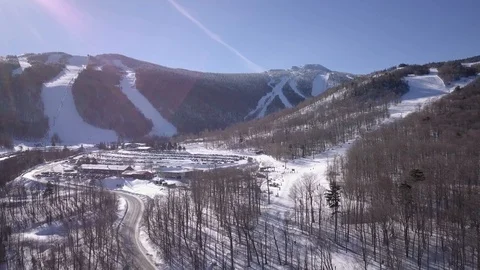 Wide Drone Shot of Ski Mountain on Sunny Day Stock Footage 129456775