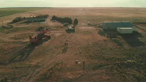 Wide Drone Shot of Two Guys Walking In a Field Video stock 229906672