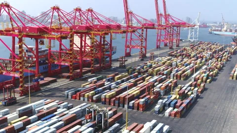 Wide drone tracking shot along a large cargo container ship being loaded 스톡 동영상 229930990