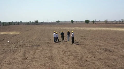 Wide drone tracking shot of a diverse team of civil engineers and site Stock Footage 337191238