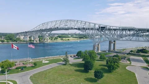 Wide Drone View of Blue Water Bridge with US and Canadian Flags Stock Footage 312010905