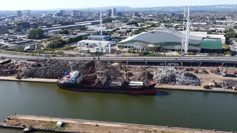 Wide Drone View of Excavators Loading Scrap Metal onto Cargo Ship at Industrial Stock Footage 344988965