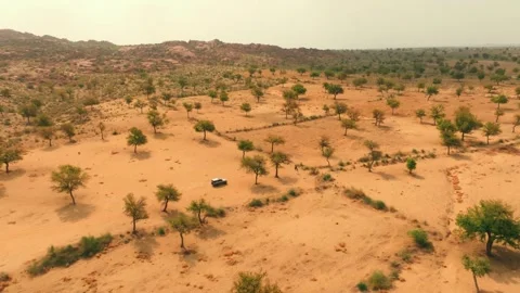 Wide drone view of a lone 4x4 crossing the Thar Desert in Sindh, Pakistan Stock Footage 345846377