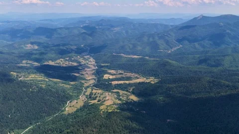 Wide drone view of lush valley near Jahorina with distant villages Video stock 314328912