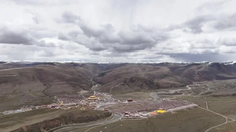 Wide drone view of mountain road crossing rugged terrain in China Stock Footage 337893979