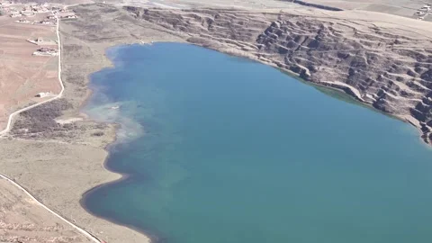 Wide drone view of mountain road crossing rugged terrain in China Stock Footage 337900208