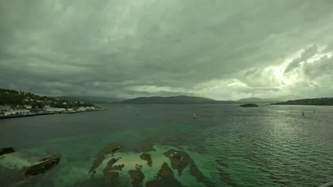 Wide elevated view over turquoise fjord water and shoreline in Senja Norway Vidéo 342340377