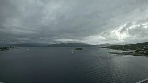 Wide elevated view over wide fjord with island and sailboat in Senja Norway Video stock 342340376