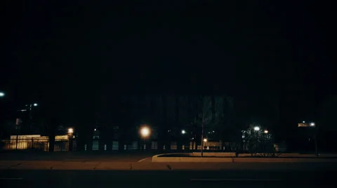 Wide establishing shot of a generic building / school / campus / at night. Stock Footage