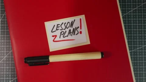 Wide establishing shot of Lesson Plans red teacher binder Stock Footage 341269464