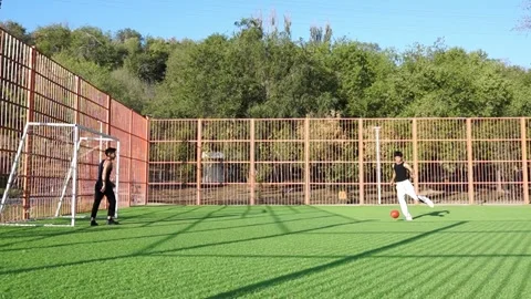 Wide field view, young men playing football, morning outdoors Stock Footage 318434682