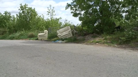 Wide fly tipping of two old sofas 05 Stock Footage 49952348