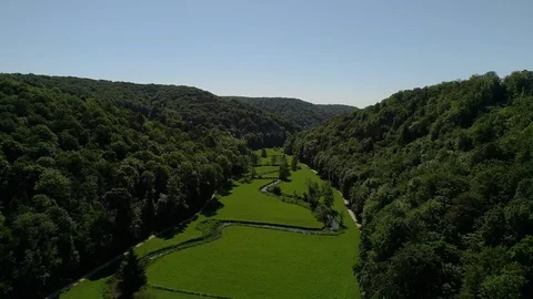 Wide Flyover above beautiful small River on the Countryside Stock Footage 112065077