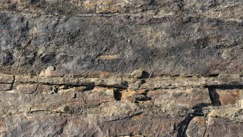 Wide format background of stone surface covered with cracks and unevenness Stock Photos