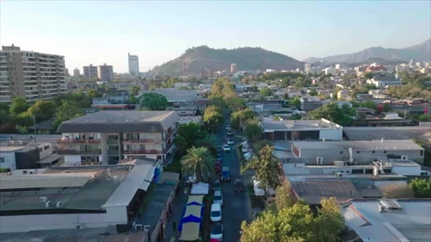 Wide forward drone above street with hill background in Santiago 스톡 동영상 340992454