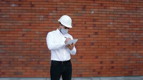 Wide frame with a Caucasian engineer wearing special equipment and a protective Stock Footage 140288983