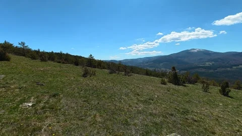 Wide grassy hill under clear blue sky. Balkan, Eastern Europe, POV 스톡 동영상 333440411