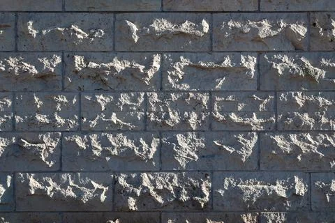 Wide gray stone wall texture with rough masonry pattern background Photos