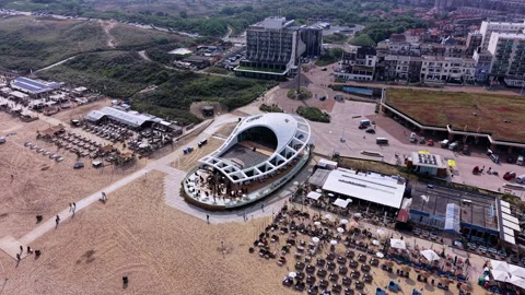 Wide high-angle aerial drone view of Scheveningen beach resort featuring Stock Footage 337935720