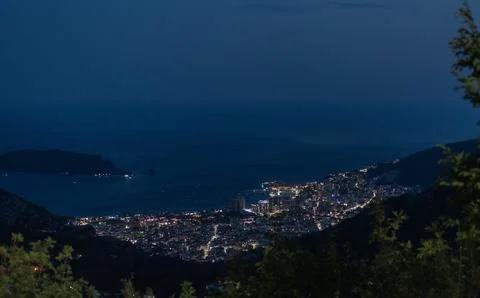 Wide high-angle night view of the illuminated city of Budva, Montenegro Stock Photos