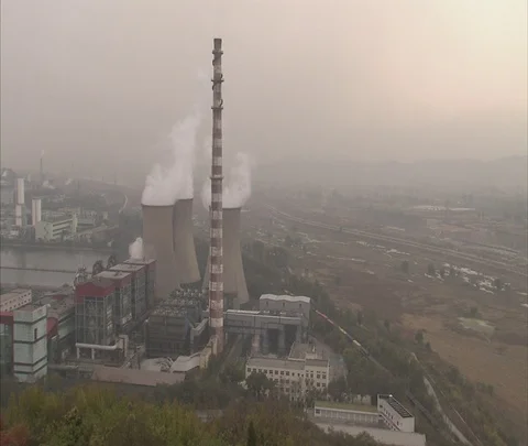 Wide high angle view of coal burning power plant with smoke from cooling towers Stock Footage 86744557