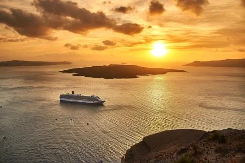 Wide high angle view of a cruise ship anchored in the Santorini caldera durin Stock Photos
