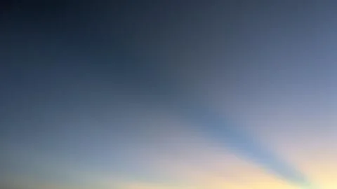 A wide horizontal shot captures distinct crepuscular sun rays shining diago.. Stock Photos