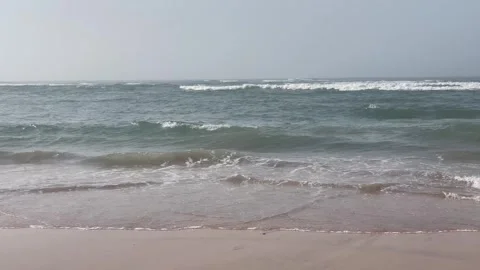 Wide Horizontal View of Ocean Waves Washing onto Beach Shoreline Stock Footage 340774866