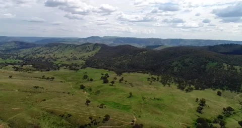 Wide hovering over green pastures and hill ranges in Sofala NSW as 4k. Stock Footage 157944528
