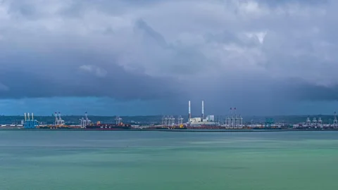 Wide Hyperlapse of Industrial Port with Cranes and Smokestacks Under Cloudy Sky Stock Footage 344428135