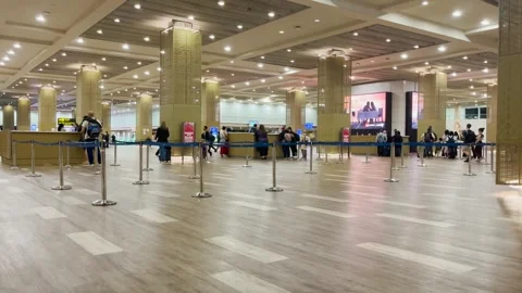 Wide Interior View of Passengers Waiting in a Queue at an Immigration Terminal Stock Footage 331301214