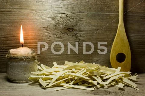 Wide Italian Noodles And Wooden Spoon On Wooden Background