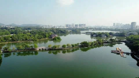 Wide lake divided by a tree-lined pedest... | Stock Video | Pond5