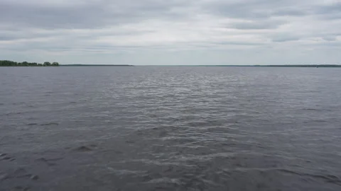 Wide lake view under overcast cloudy sky Stock Footage 344880770