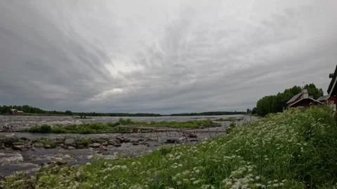 Wide landscape of fast rushing river rapids with rustic wooden building Stock Footage 340651690