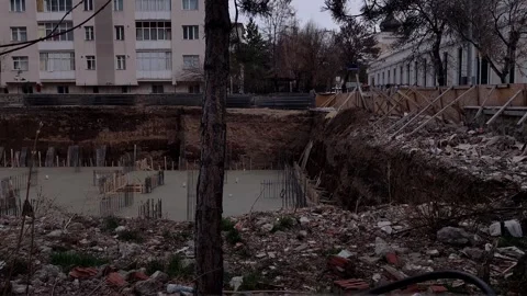 Wide landscape shot of a deep construction excavation site showing the concrete 動画素材 333554828