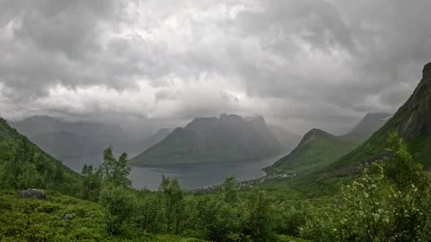 Wide landscape view of dramatic misty fjord valley and village in Senja Norway Stock-Footage 342059371