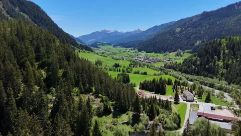 Wide Landscape View of Green Valley Village and Forested Slopes Видео 344238426
