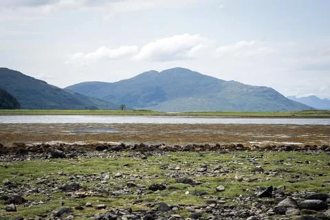 Wide landscape view of mountain range and calm lake Stock Photos
