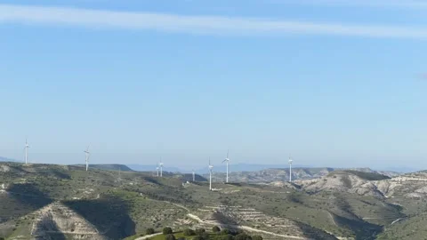 Wide landscape view of rolling hills with wind turbines on the horizon Stock Footage 332810548