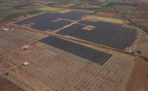 Wide low-angle aerial shot overlooking a vast dry brown agricultural field Stock Footage 341660895