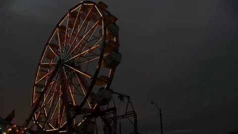 Wide Low Angle of Ferris Wheel and Dark Sky Stock Footage 92765119