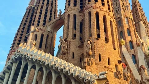 Wide low-angle shot of facade of Sagrada Família with angular sculptures, sharp Stock Footage 331959662