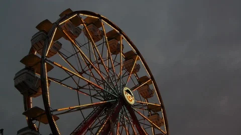 Wide Low Angle Shot of Moving Ferris Wheel with Lights Stock Footage 92765337
