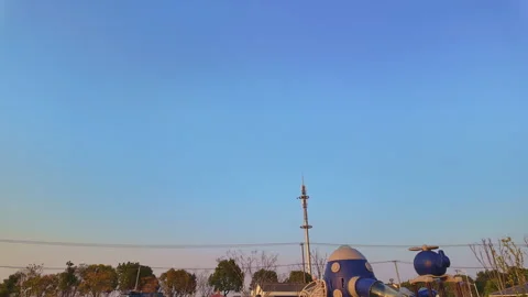 Wide Low Angle Shot of Vast Clear Gradient Sky Over Space Themed Suburban Stock Footage 334872252