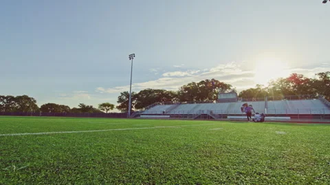 Wide low angle shot of a young athlete running with a parachute during a workout Video stock 305290853