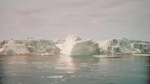 A wide low angle view of melting sea ice floes in still waters of Arctic Illustrazione stock