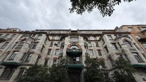 Wide low angle view of a multi-story residential brick building in art nouveau Stock Photos