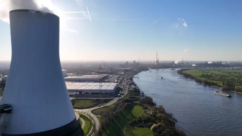 Wide meadow flight with cooling tower over river Video stock 331204775