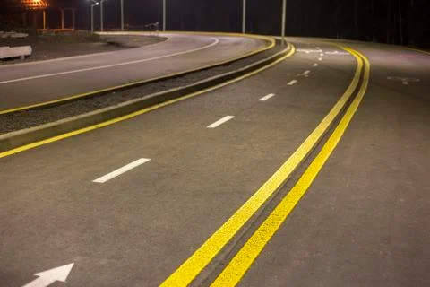 Wide modern smooth empty asphalt highway sharp turn sharp with bright white a 스톡 사진